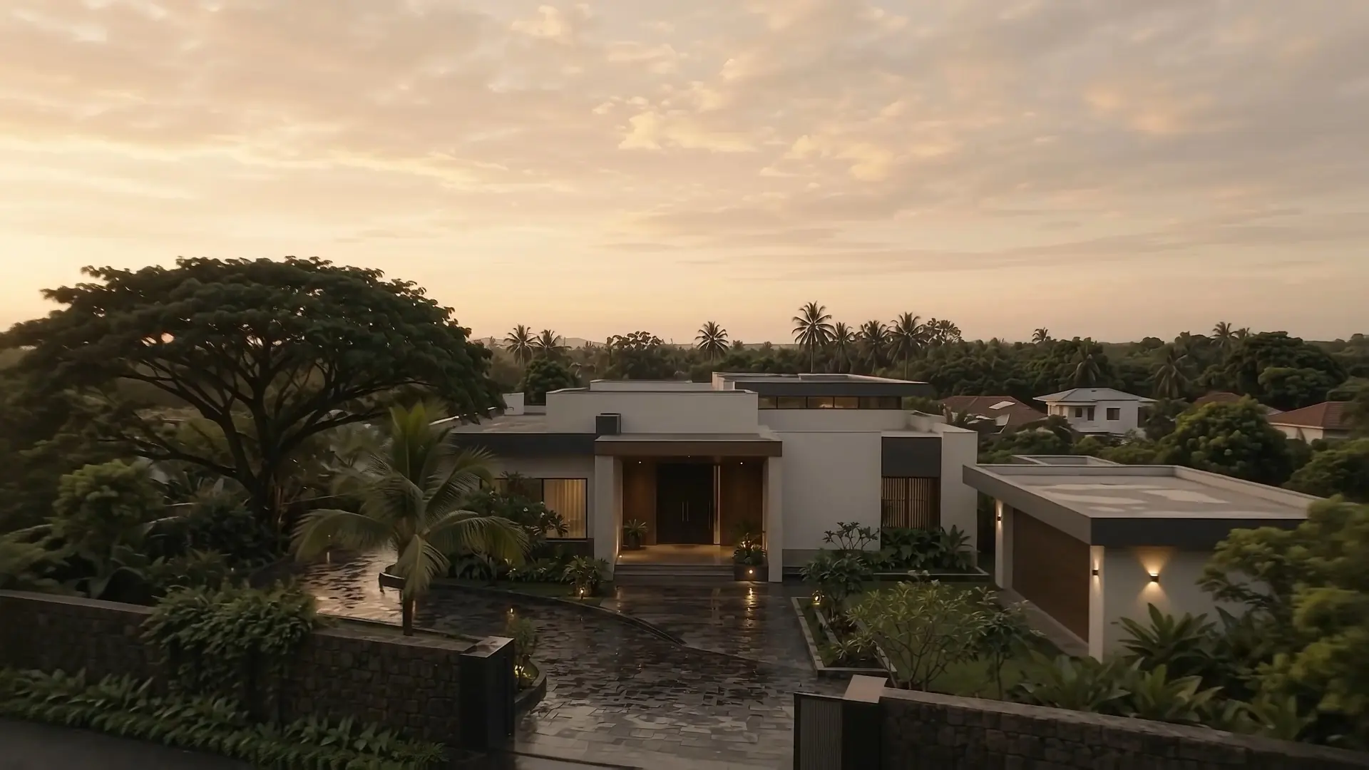 A contemporary Kerala residence after the rain, seen from above at golden hour.